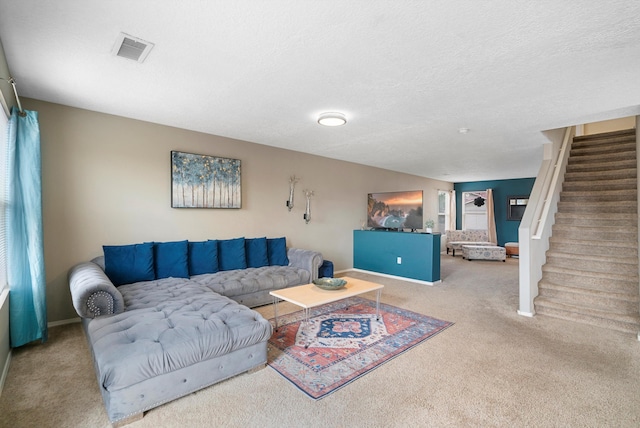 living room with carpet flooring and a textured ceiling