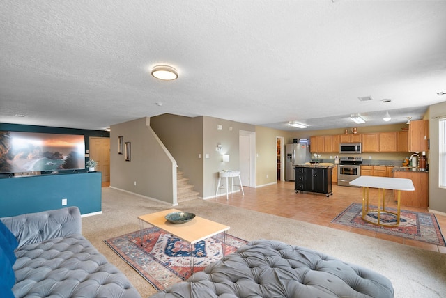 living room with light tile patterned floors and a textured ceiling