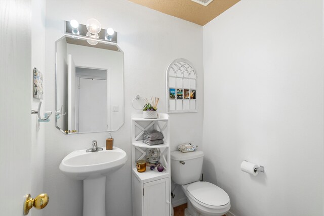 bathroom with toilet and sink