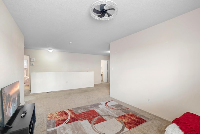 living room with light carpet and a textured ceiling