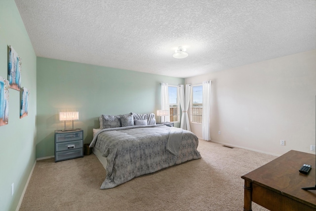 carpeted bedroom with a textured ceiling