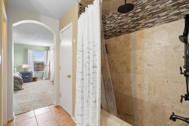 bathroom featuring tile patterned floors, a textured ceiling, and a shower with shower curtain