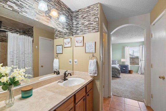 bathroom with vanity, tile patterned flooring, a shower with curtain, and a textured ceiling