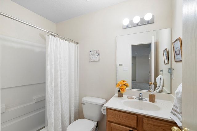 full bathroom featuring toilet, vanity, and shower / bathtub combination with curtain