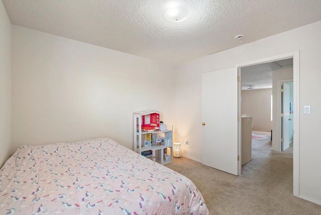 bedroom with light carpet and a textured ceiling