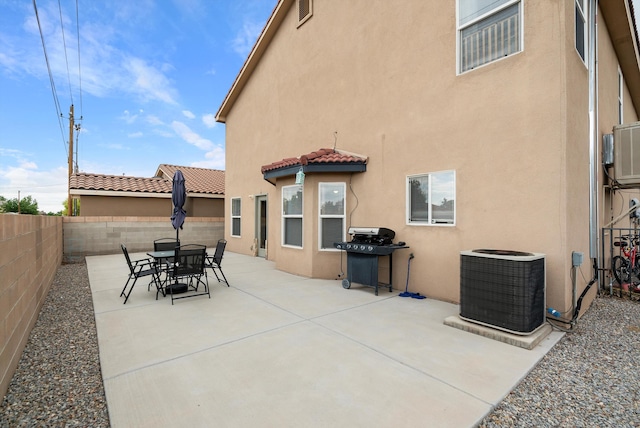 back of house featuring central AC unit and a patio area