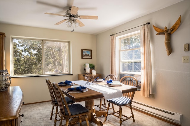 carpeted dining room featuring a baseboard radiator and ceiling fan