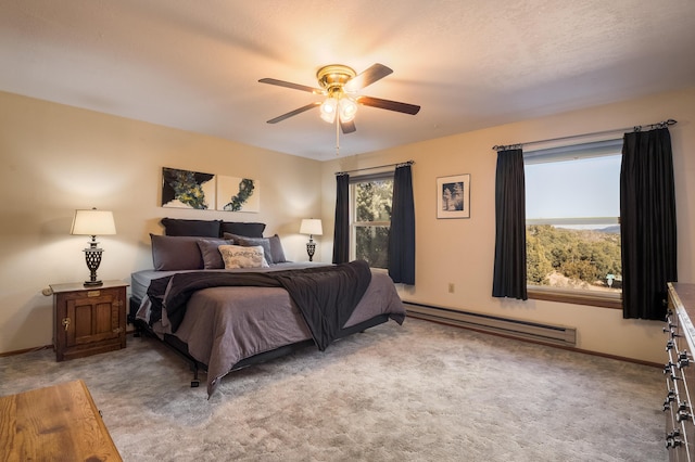 bedroom featuring ceiling fan, light carpet, and a baseboard heating unit