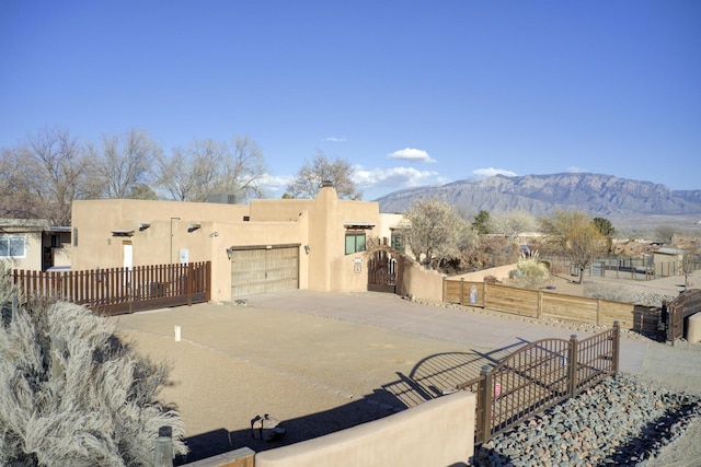 view of front facade with a garage and a mountain view