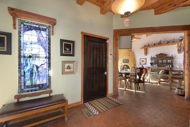 entrance foyer with beamed ceiling, ceiling fan, and wooden ceiling