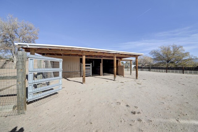 rear view of property featuring an outbuilding