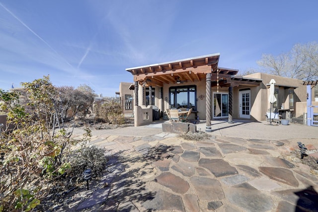 back of house featuring a patio and ceiling fan