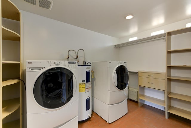 washroom featuring washer and dryer and water heater