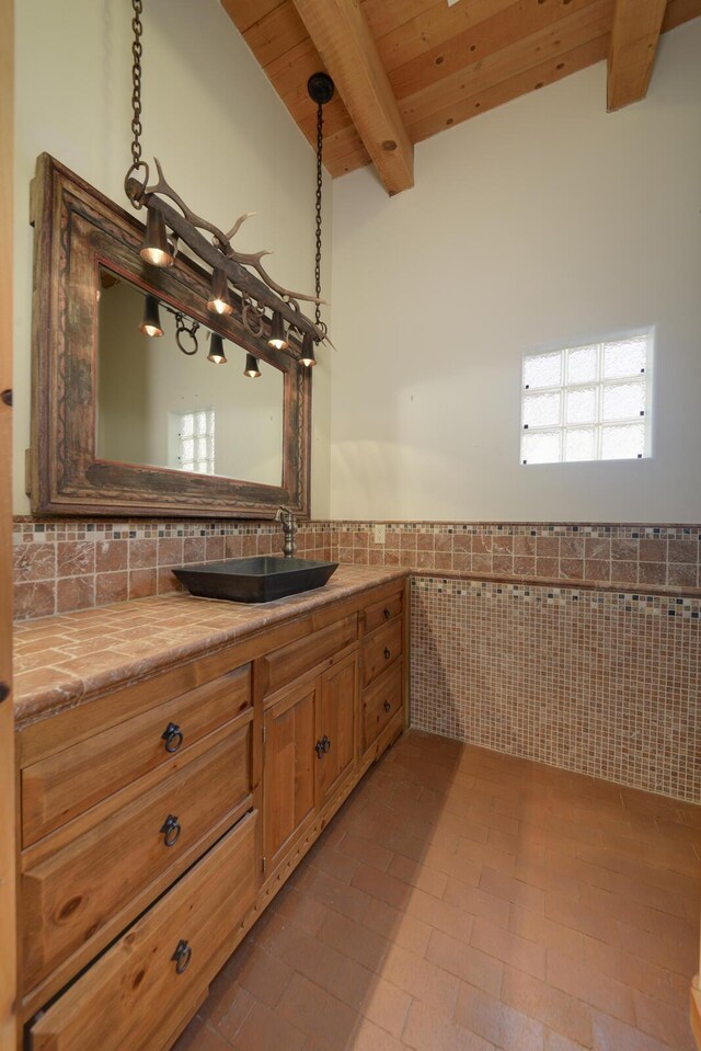 interior space with wood ceiling, a high ceiling, washing machine and clothes dryer, french doors, and beamed ceiling