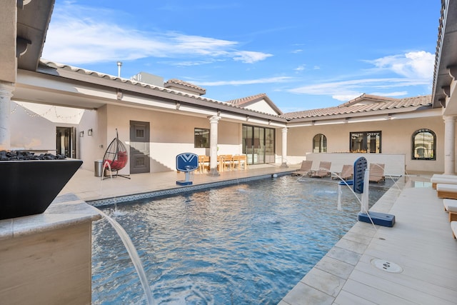 view of swimming pool with a patio and pool water feature