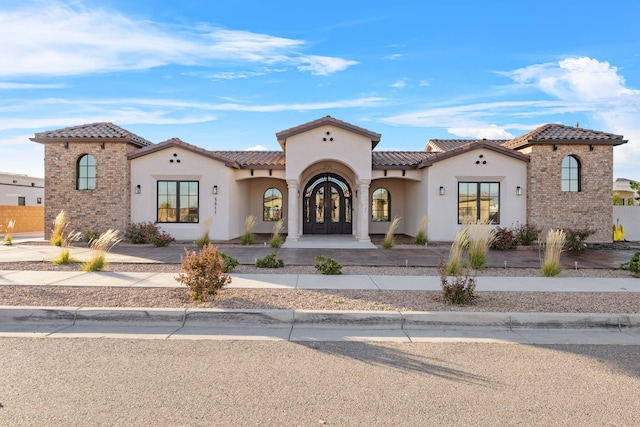 mediterranean / spanish-style home with french doors