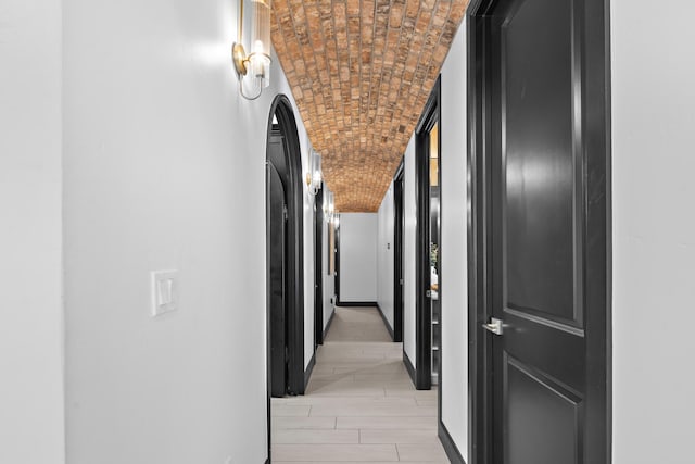 hall with brick ceiling and vaulted ceiling