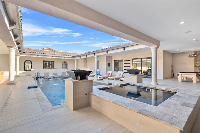 view of pool with a jacuzzi and pool water feature