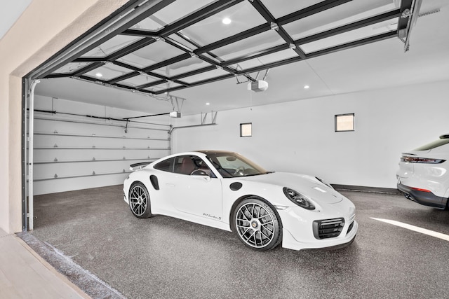 garage featuring a garage door opener and a carport