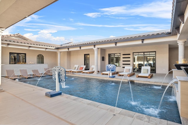 view of pool featuring pool water feature and a patio