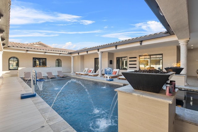 view of pool with pool water feature and a patio area