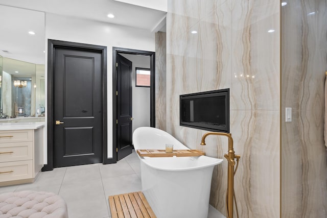 bathroom with vanity, tile patterned flooring, and a tub