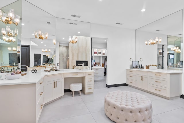 bathroom with vanity, tile patterned flooring, and a notable chandelier