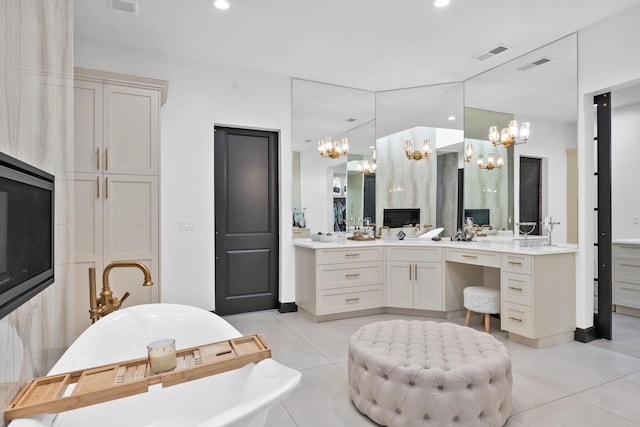 bathroom with vanity, tile patterned floors, a tub, and a chandelier