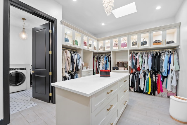 spacious closet with a skylight and washer / dryer