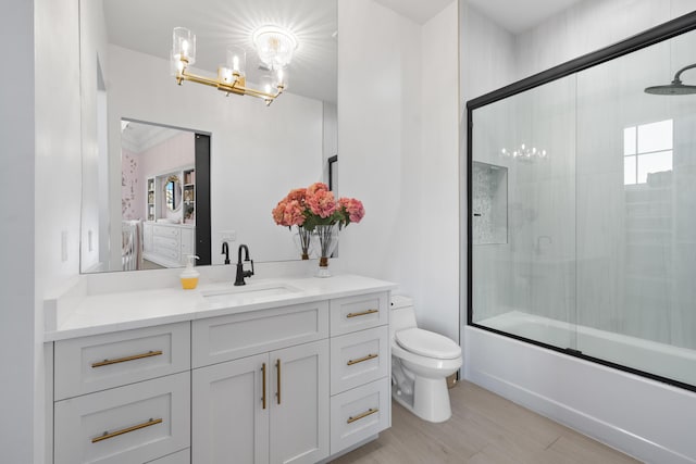 full bathroom with vanity, wood-type flooring, enclosed tub / shower combo, and toilet