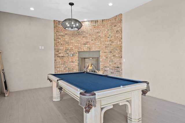 game room featuring billiards, a fireplace, and light hardwood / wood-style floors