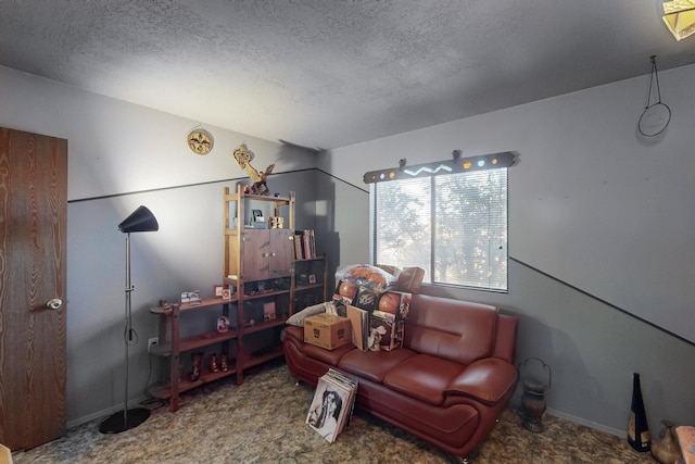 carpeted living room featuring a textured ceiling