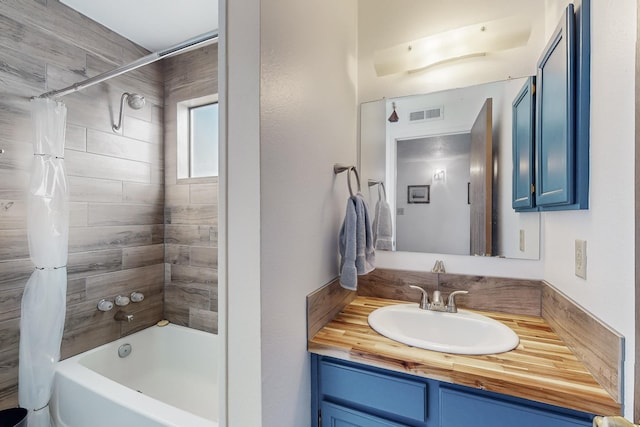 bathroom featuring vanity and shower / bathtub combination with curtain