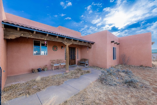 property entrance featuring a patio area