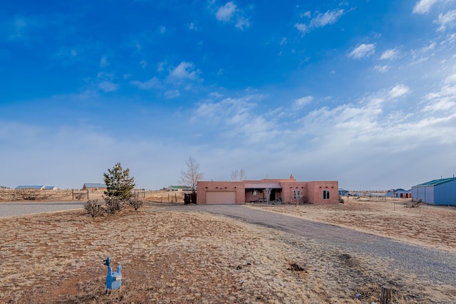 adobe home featuring a garage