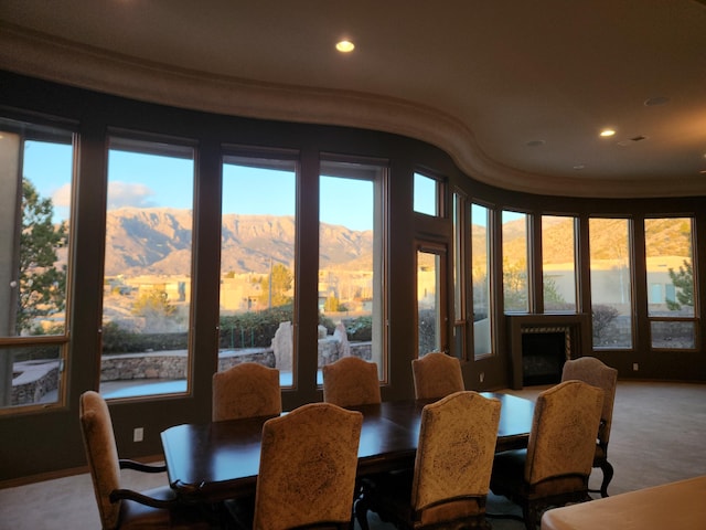 carpeted dining room with a mountain view