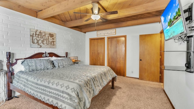 carpeted bedroom with multiple closets, wooden ceiling, and beam ceiling