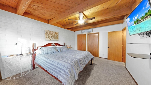 bedroom featuring carpet, ceiling fan, wood ceiling, multiple closets, and beam ceiling