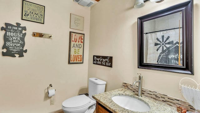 bathroom featuring vanity and toilet