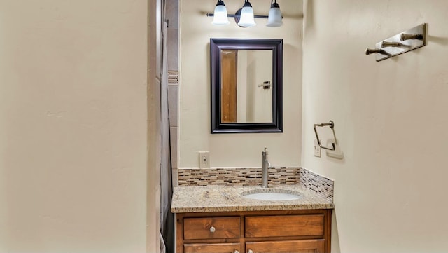 bathroom with vanity and tasteful backsplash