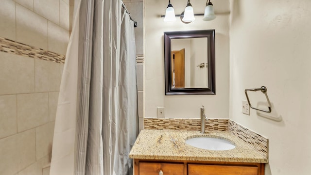 bathroom featuring vanity, decorative backsplash, and a shower with shower curtain