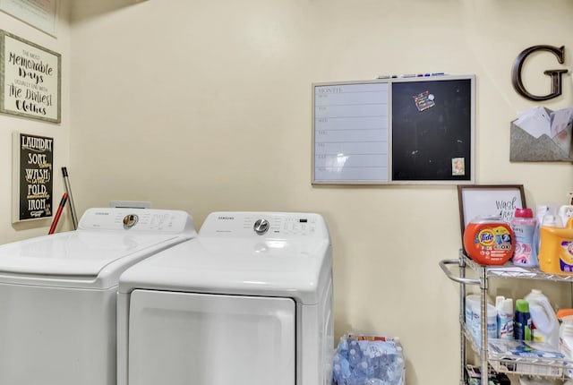 laundry area with washing machine and clothes dryer