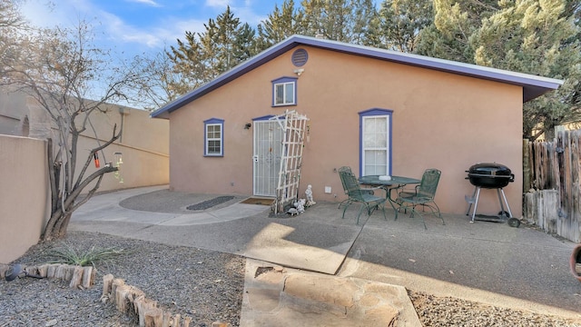 back of property with a patio