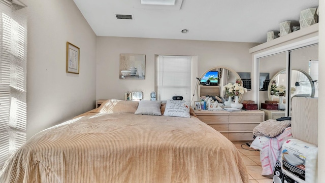 tiled bedroom featuring a closet