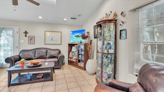 living room with a wealth of natural light, light tile patterned floors, and ceiling fan