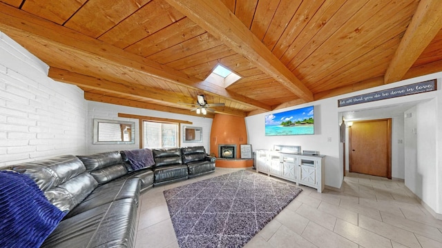 living room featuring light tile patterned floors, wood ceiling, ceiling fan, beam ceiling, and a skylight