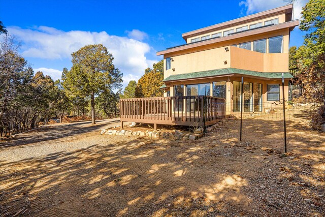 back of property with a wooden deck