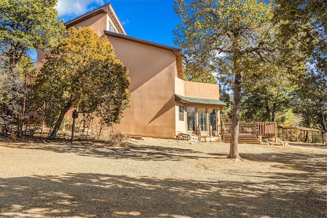 view of home's exterior featuring a deck and stucco siding