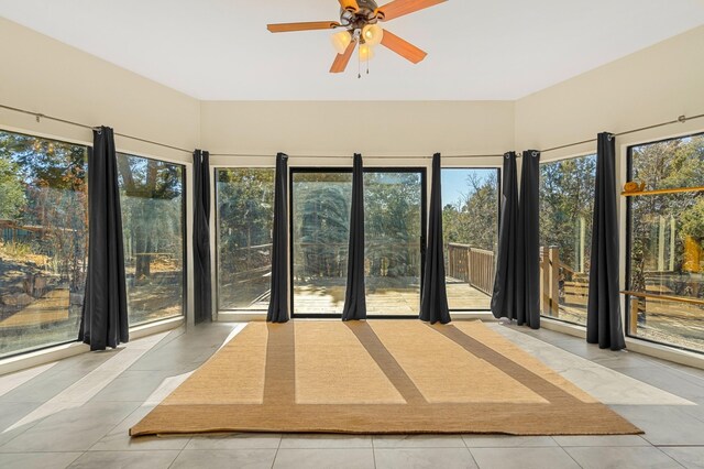 unfurnished sunroom with a ceiling fan