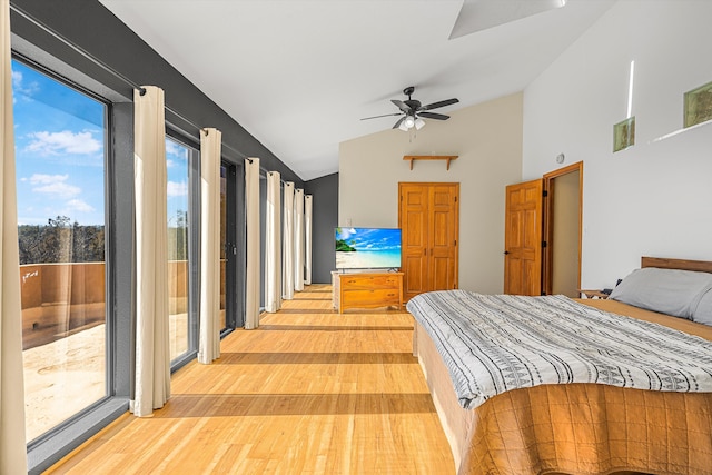 bedroom featuring access to outside, vaulted ceiling, light wood-style flooring, and ceiling fan